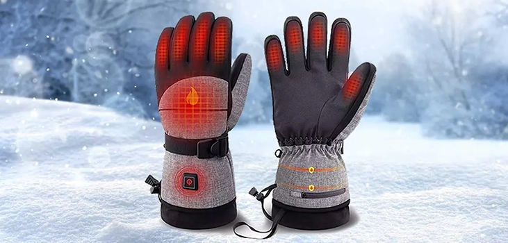 VolteX Heated Gloves on snowy background